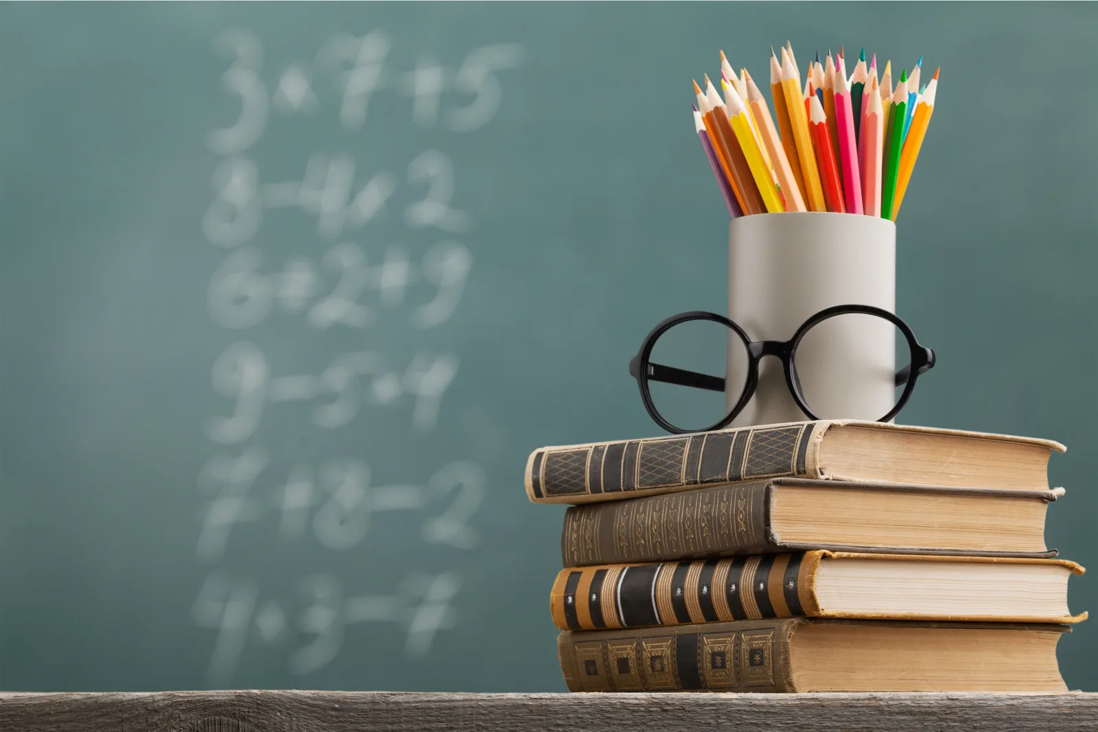 Books and coloured pencils in a classroom